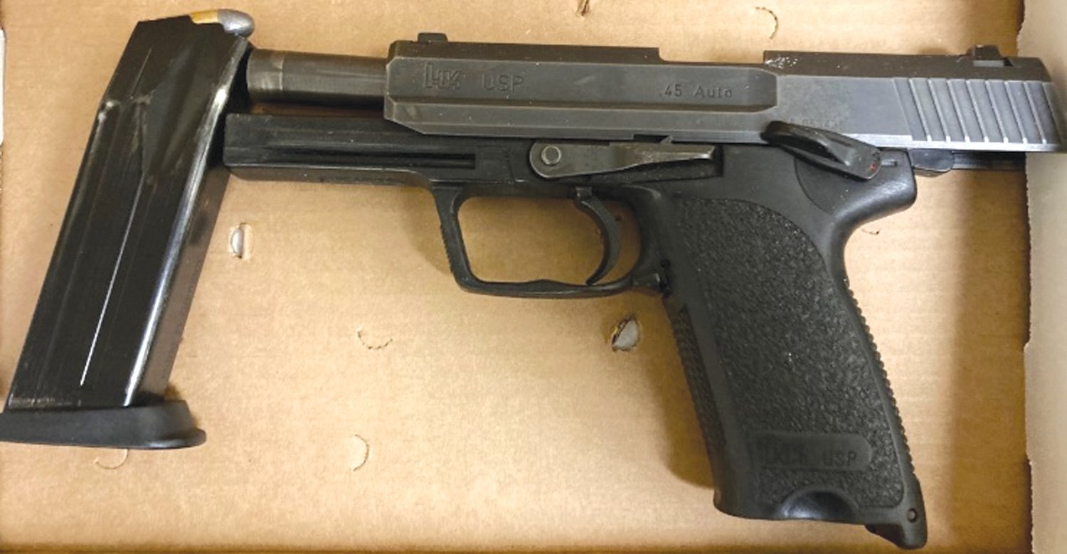 SEIZED ITEMS: Cranston police said they seized this a
loaded .45 caliber handgun and a bag of pills following a
traffic stop. Police said the bag contained 49 counterfeit